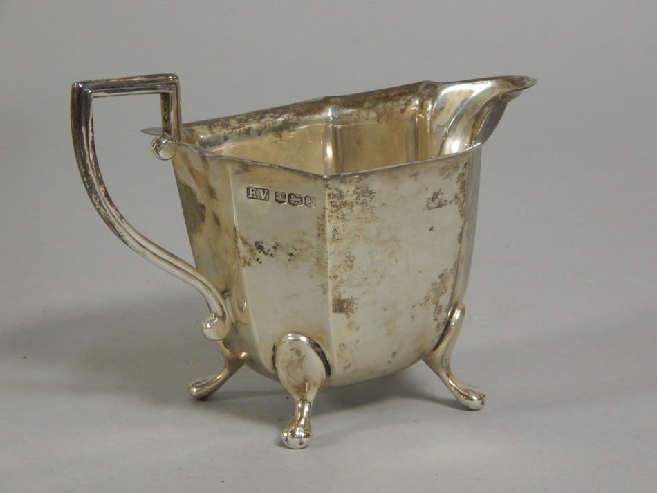 Appraisal: A George VI silver canted rectangular cream jug on three