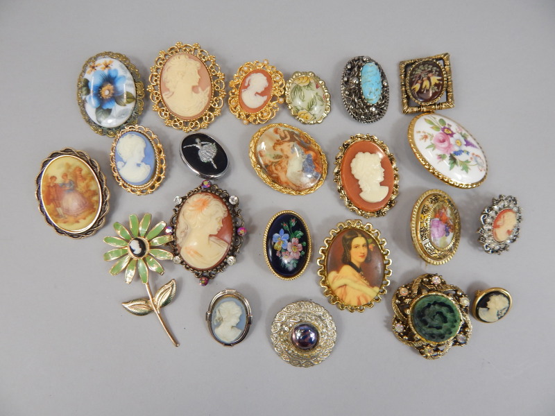 Appraisal: Various painted brooches cameo brooches on gold plated and silver