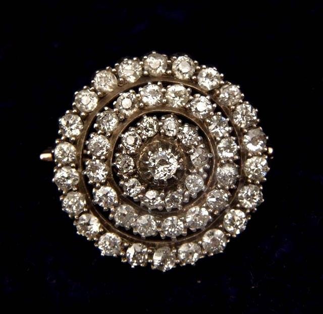 Appraisal: A LATE VICTORIAN DIAMOND SET CIRCULAR BROOCH with central claw