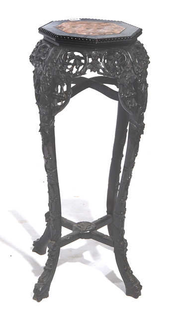 Appraisal: A CHINESE CARVED HARDWOOD LARGE URN STAND with prunus and