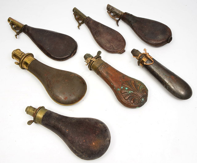 Appraisal: A GROUP OF SEVEN ANTIQUE POWDER FLASKS to include a