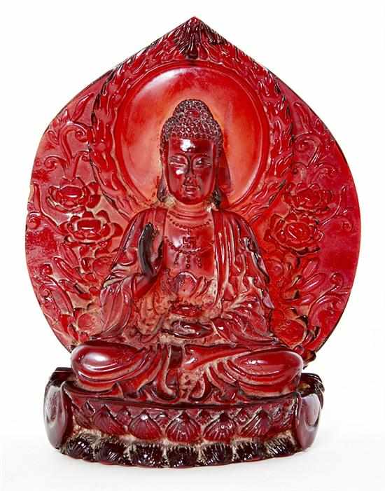 Appraisal: Thai carved amber Buddha seated in meditation position on lotus