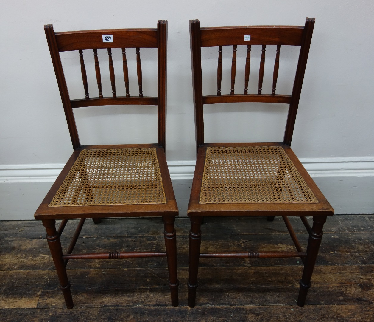 Appraisal: A pair of Edwardian walnut frame cane seat bedroom chairs