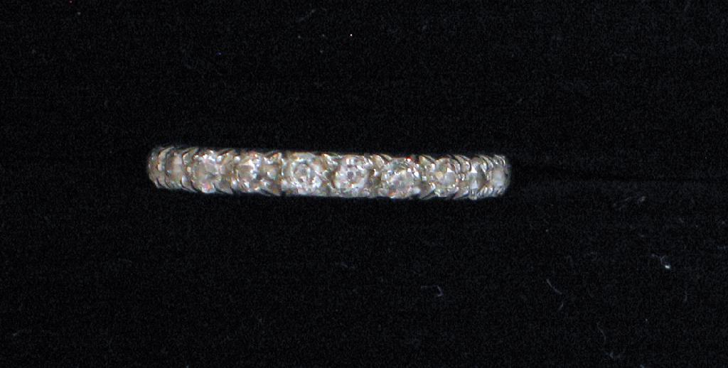 Appraisal: A FULL DIAMOND ETERNITY RING the white metal set with