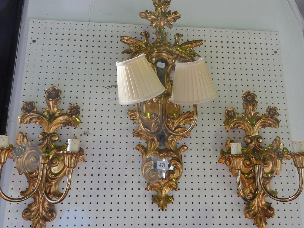 Appraisal: A gilt wall light with a foliate crest flanked by