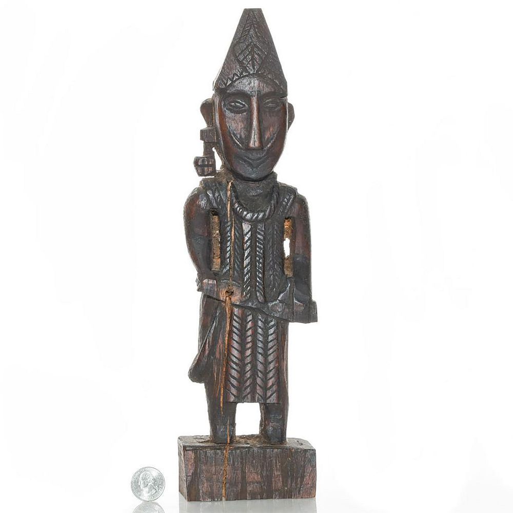 Appraisal: HAND CARVED AFRICAN WARRIOR WOODEN SCULPTURE Man with warrior clothing