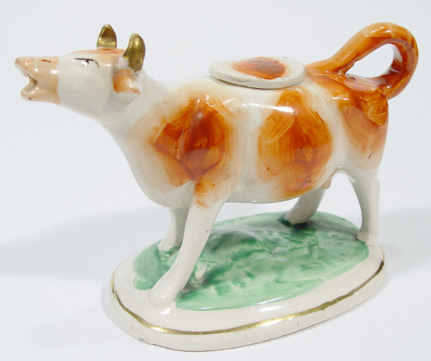 Appraisal: Victorian Staffordshire cow creamer painted in brown with gilt highlights