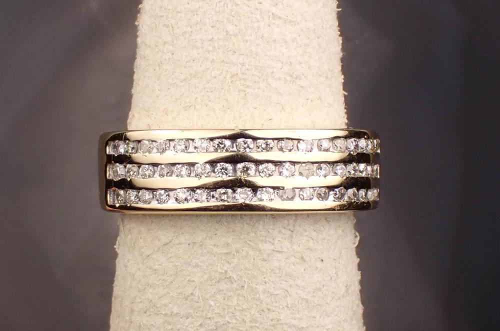 Appraisal: DIAMOND AND FOURTEEN KARAT YELLOW GOLD RING channel set with