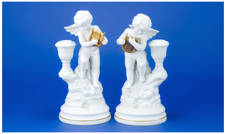 Appraisal: Pair of White Bisque Amorini di Pompeii Candlesticks with Gilded