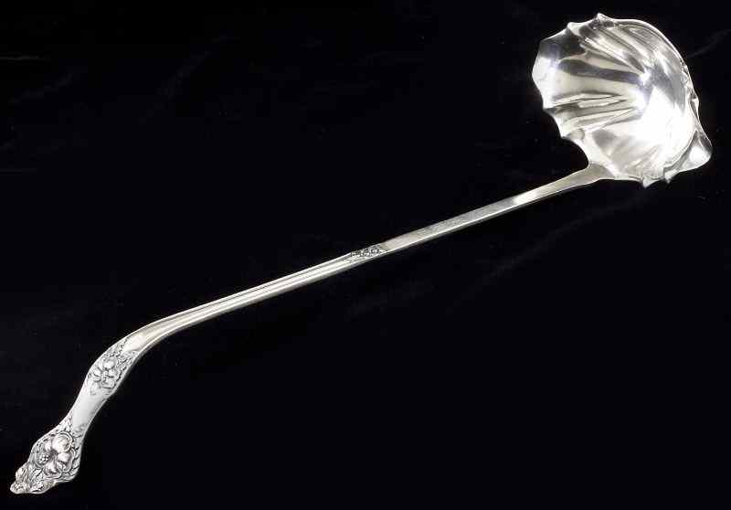 Appraisal: Art Nouveau Sterling Punch Ladle by Bakerwith a hibiscus flower