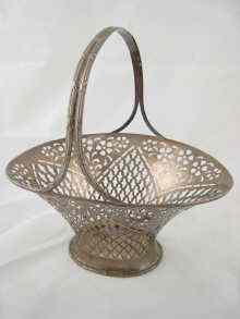 Appraisal: An American oval silver basket with pierced decoration ribbon handle