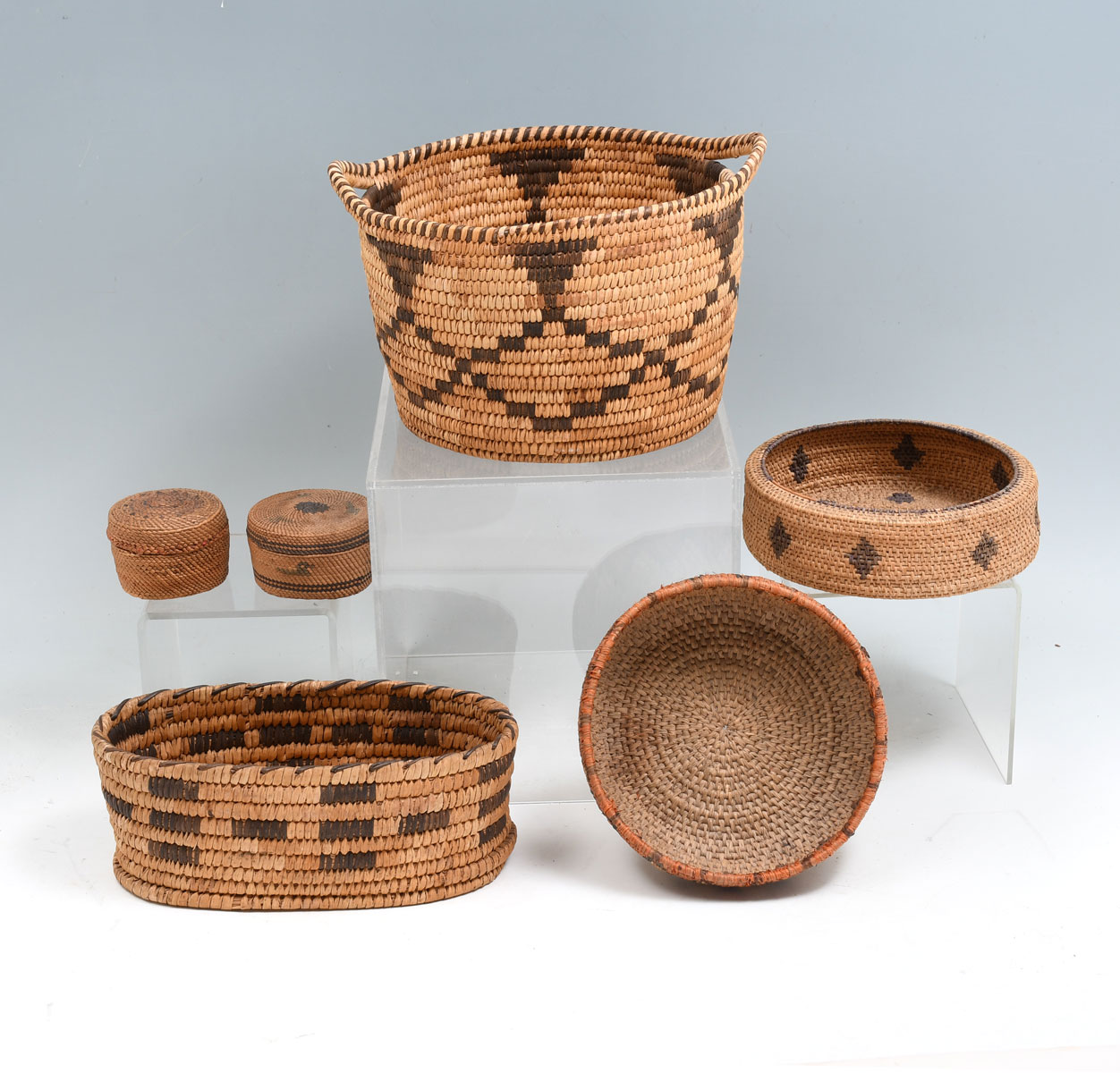 Appraisal: AMERICAN INDIAN WOVEN BASKETS Southwest Apache handled basket with geometric