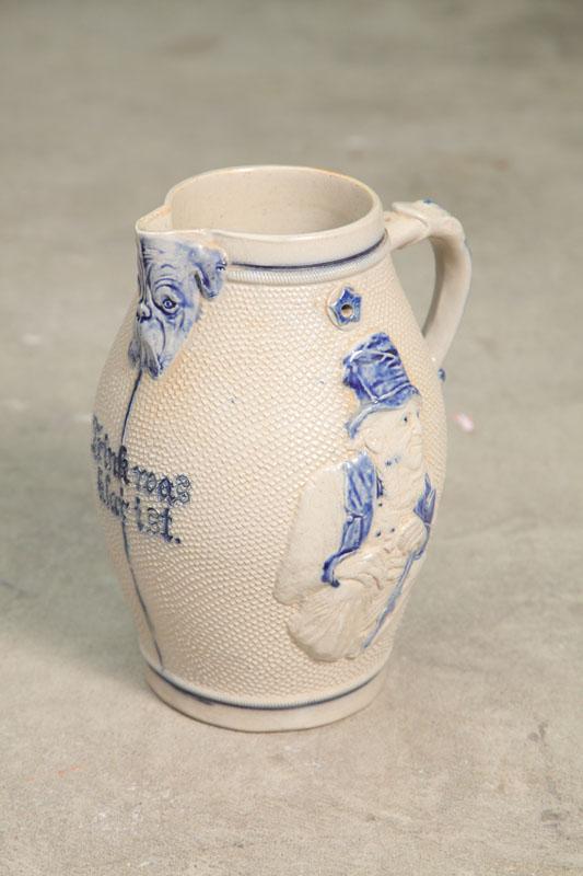 Appraisal: STONEWARE PITCHER Decorated with embossed figures of men and a