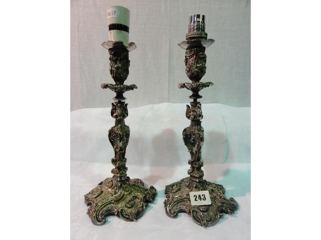 Appraisal: A pair of silver plated lamp bases with embossed scrolling