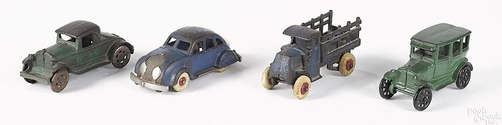 Appraisal: Four small cast iron vehicles Four small cast iron vehicles