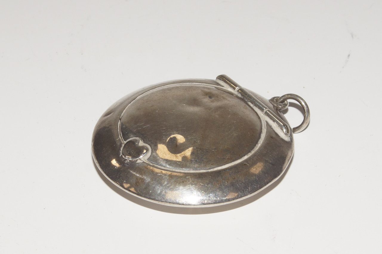 Appraisal: A silver circular pendant powder compact Birmingham