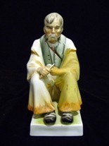 Appraisal: A Zsolnay Pecs porcelain figure of a seated man in