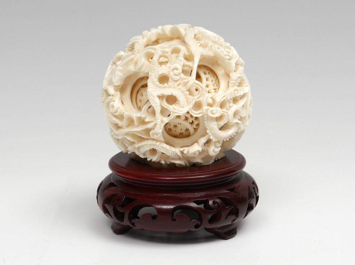 Appraisal: CARVED IVORY MYSTERY BALL Dragon motif layers '' dia Sold