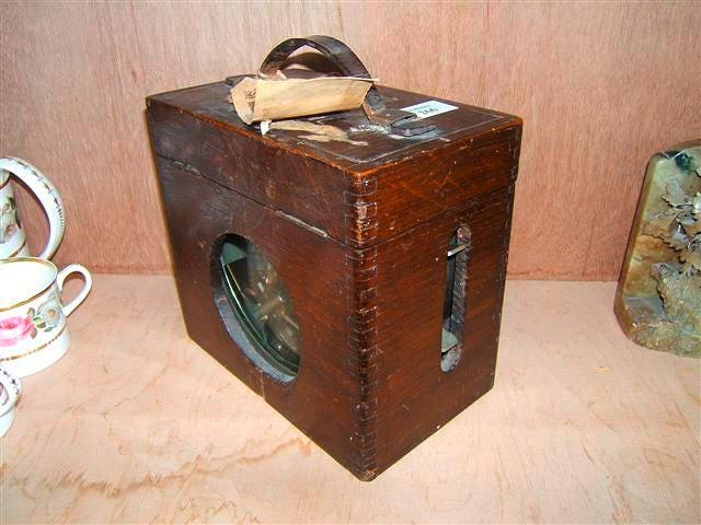 Appraisal: A Belgian clockwork pigeon timer in an oak case