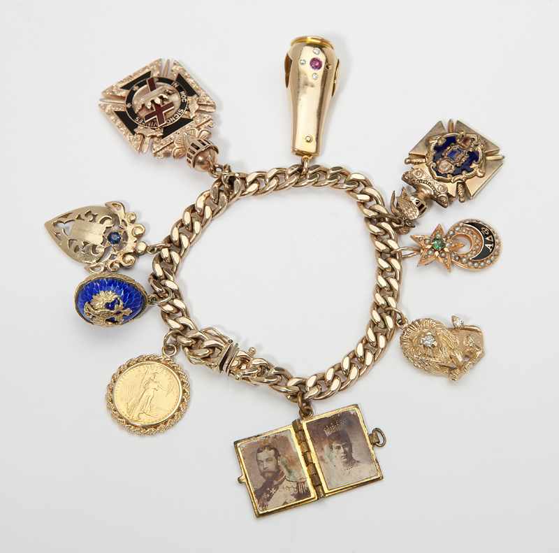 Appraisal: K gold charm bracelet with gold charms and gold-filled charms