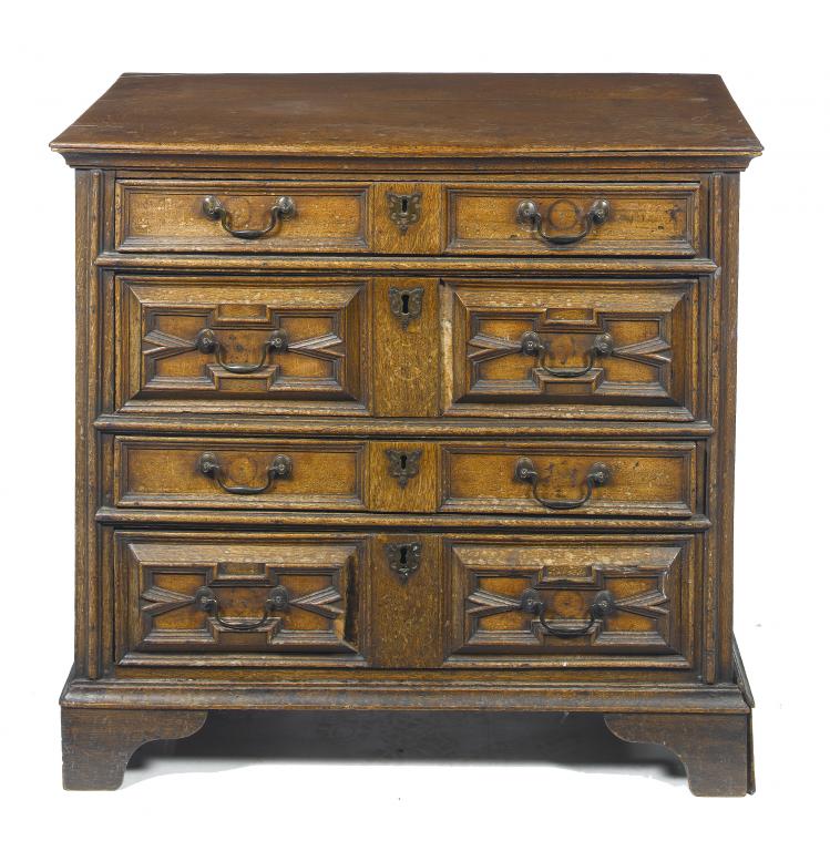 Appraisal: A WILLIAM III OAK CHEST OF DRAWERS fitted four geometrically