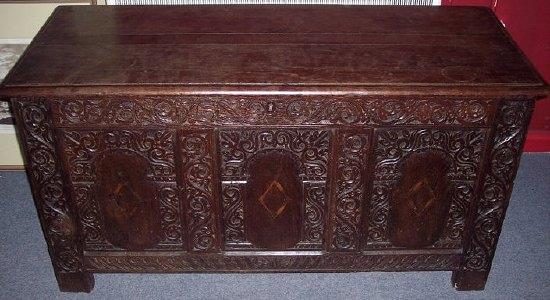 Appraisal: A th Century oak coffer with plank top on carved