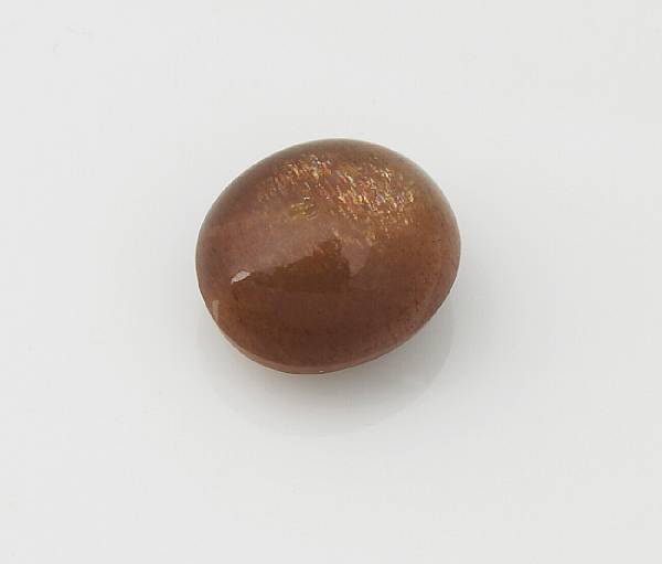 Appraisal: Sunstone An unmounted oval cabochon of golden brown color displaying