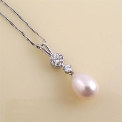 Appraisal: A cultured pearl and diamond pendant the drop shaped pearl