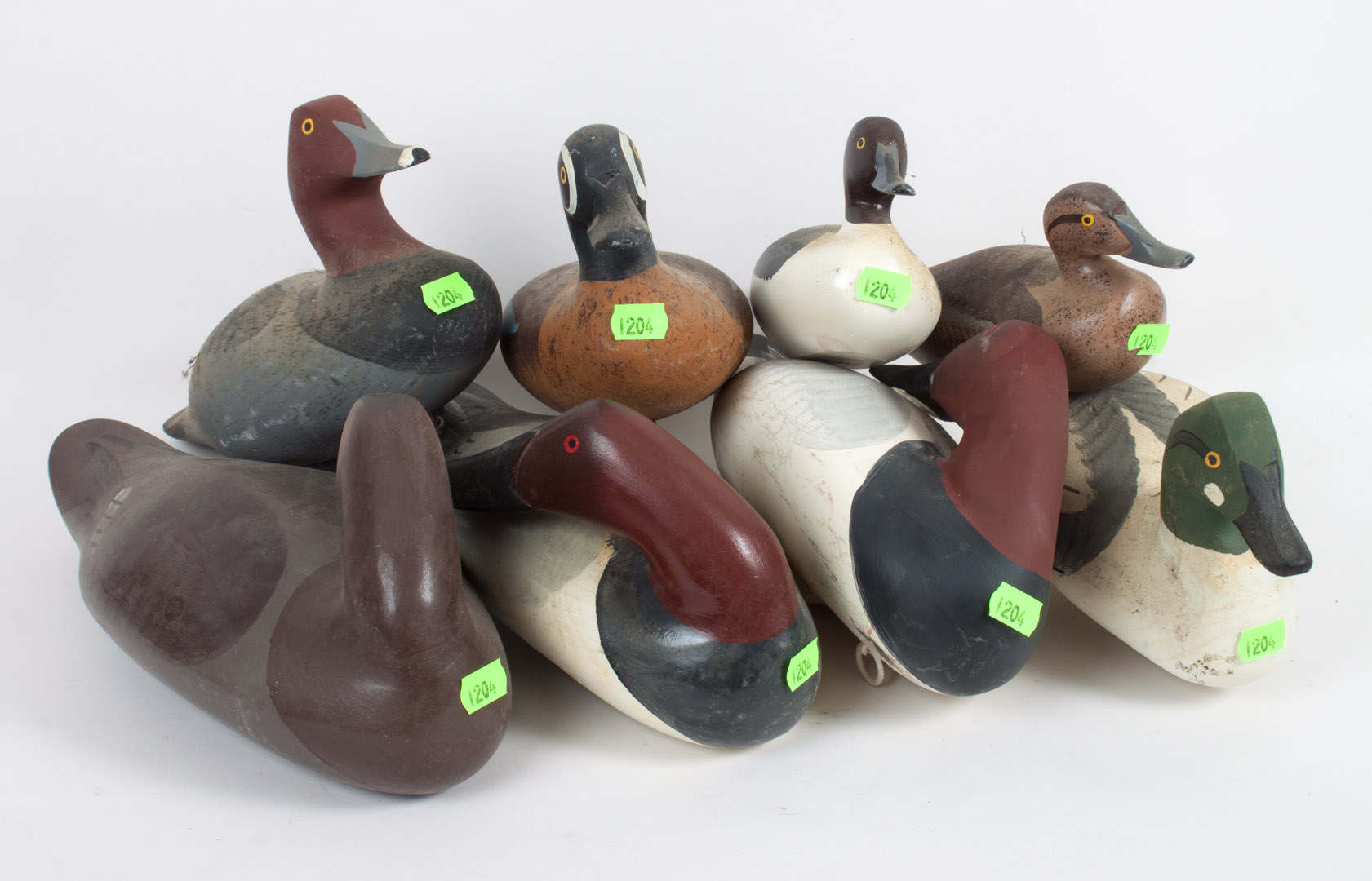 Appraisal: Four wood duck decoys and four similar figures by Captain