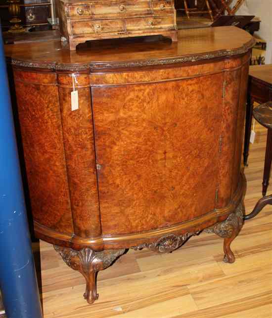 Appraisal: A carved walnut demi lune side cabinet with door on