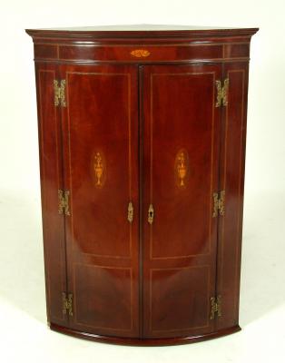 Appraisal: A GEORGE III MAHOGANY CORNER CUPBOARD of bowed form with