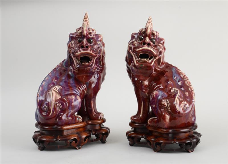 Appraisal: PAIR OF CHINESE FLAMBE-GLAZED PORCELAIN FIGURES OF KYLINS Each modeled