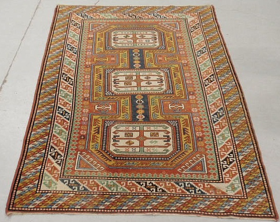 Appraisal: Caucasian oriental center hall carpet with colorful geometric medallions x