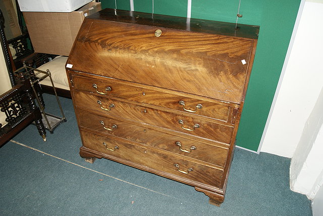 Appraisal: A GEORGE III MAHOGANY BUREAU the front fitted with four