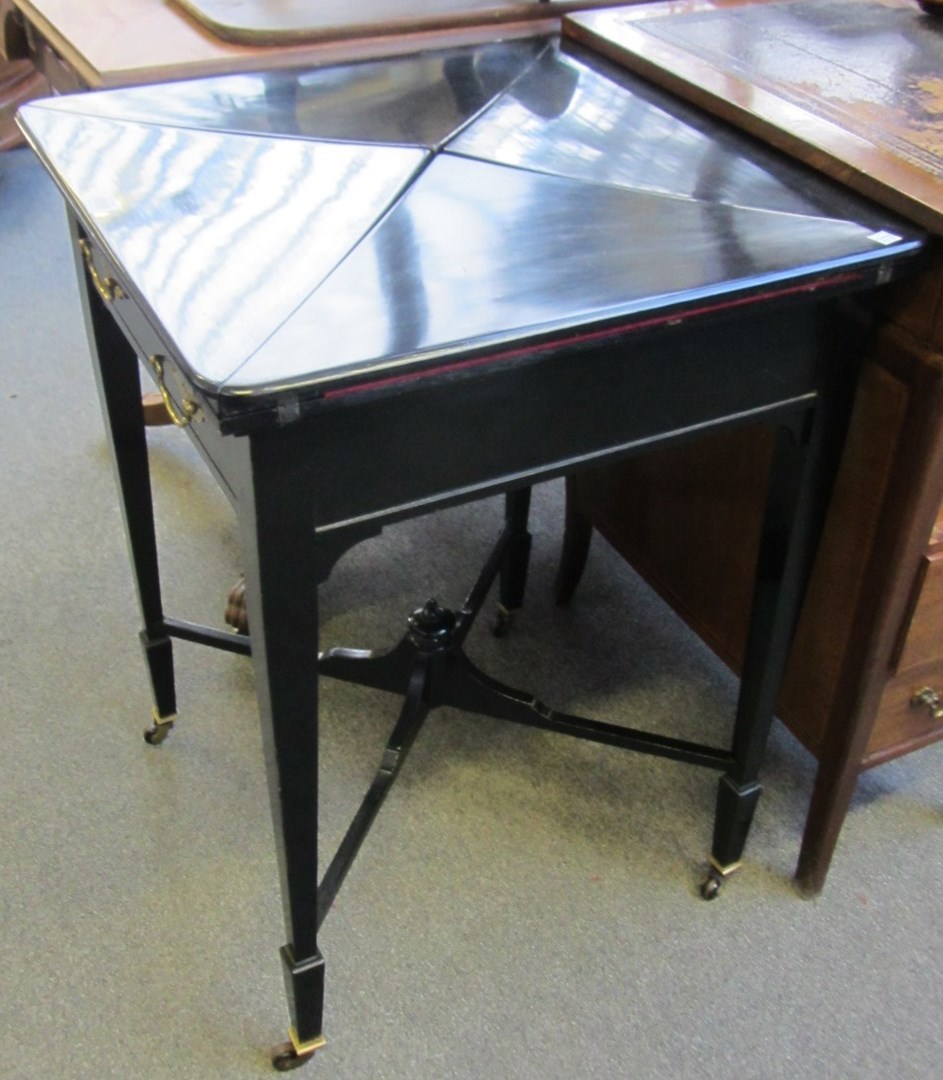 Appraisal: A late th century ebonised envelope card table with single