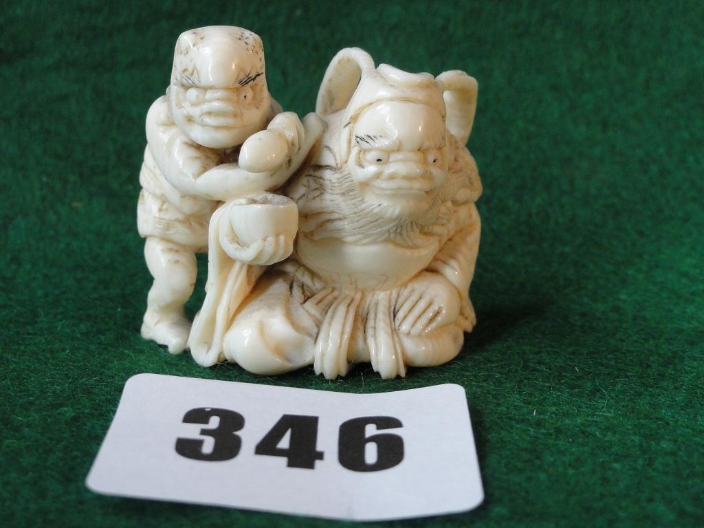 Appraisal: An ivory netsuke of two grotesque men