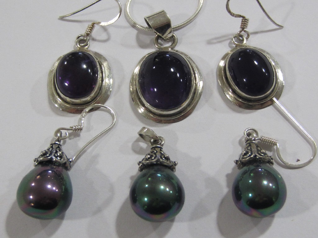 Appraisal: Amethyst set silver oval shaped pendant with matching earrings and