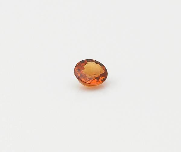 Appraisal: Orange Sapphire An unmounted oval-faceted stone having a bright orange