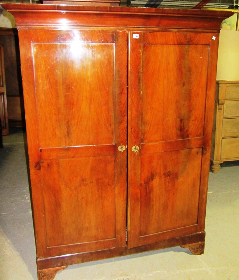 Appraisal: A small th century mahogany two door wardrobe on carved