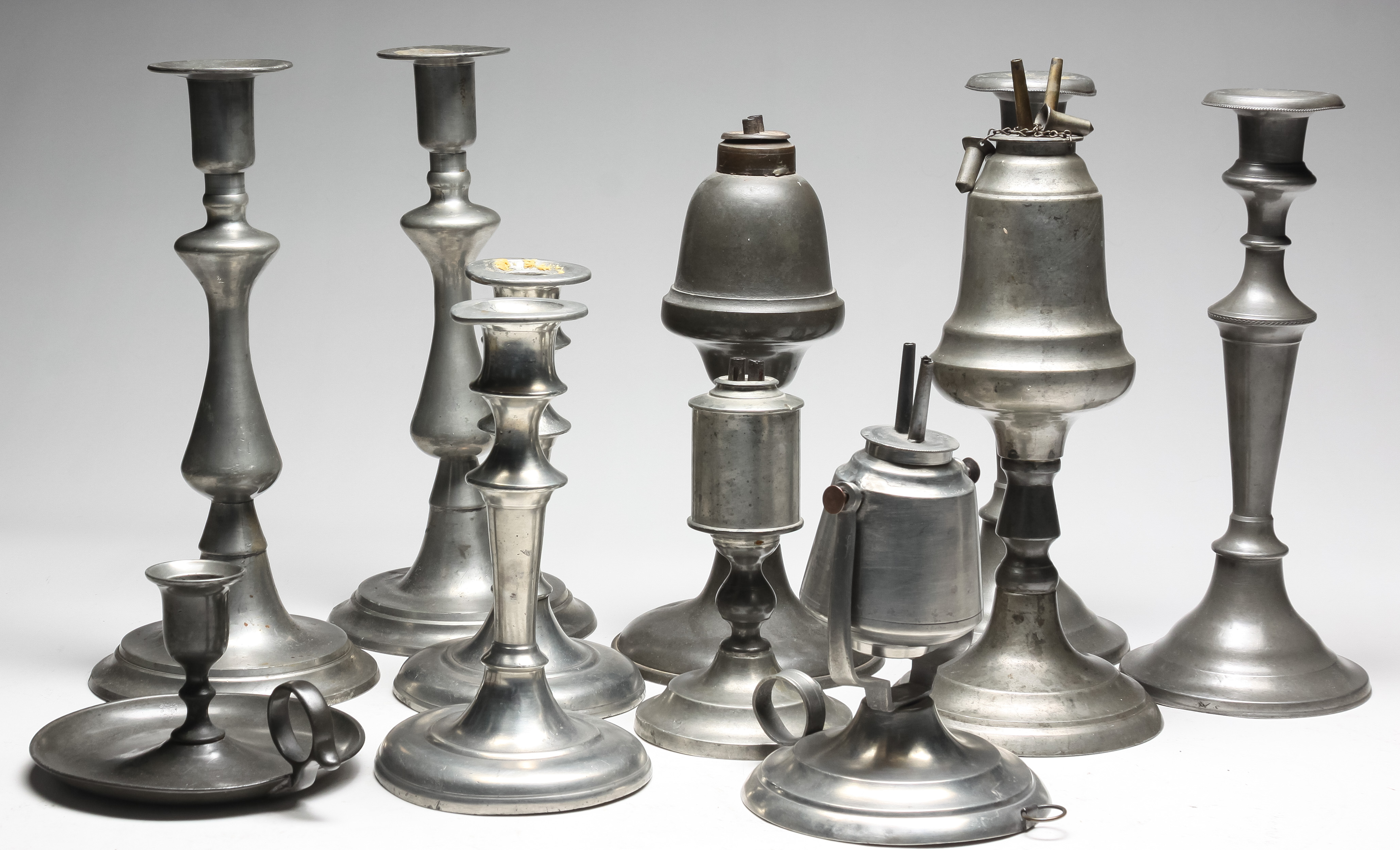 Appraisal: GROUP OF AMERICAN PEWTER LIGHTING Nineteenth century Unmarked Chamberstick three