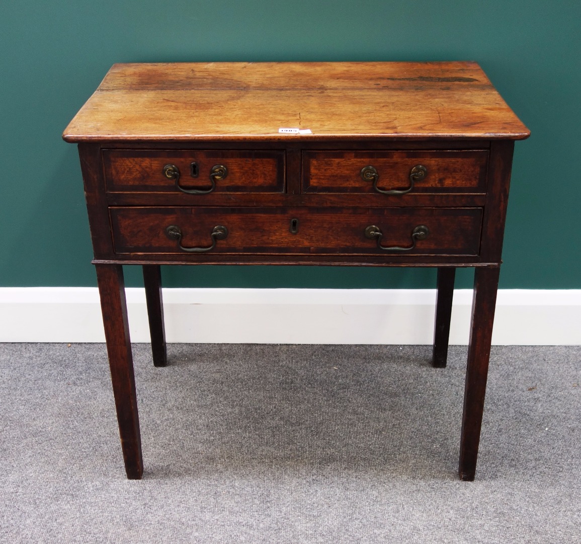 Appraisal: An th century mahogany banded oak lowboy with two short