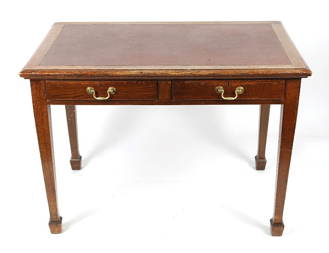 Appraisal: AN OAK RECTANGULAR WRITING TABLE with red rexine top two