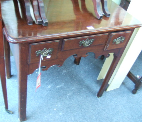 Appraisal: A George III mahogany lowboy with three drawers over a