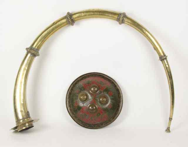 Appraisal: An Indian brass horn and a small shield