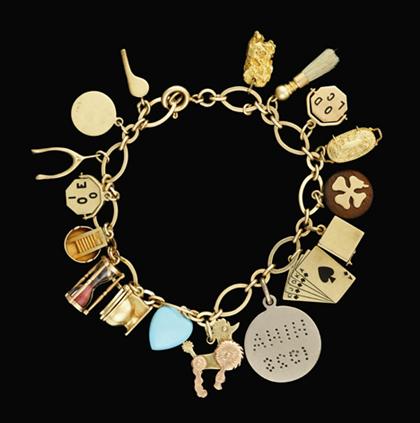 Appraisal: karat yellow gold charm bracelet Set with seventeen charms of