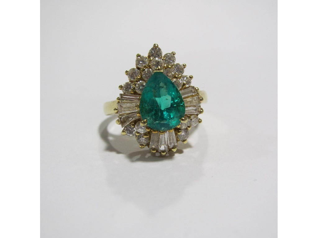 Appraisal: An eighteen carat gold emerald and diamond cluster ring with