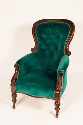 Appraisal: A mahogany armchair with deep button back on turned front