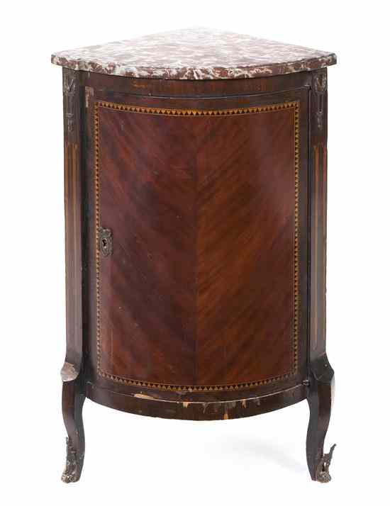 Appraisal: A Continental Mahogany Corner Cabinet of quarter round form having