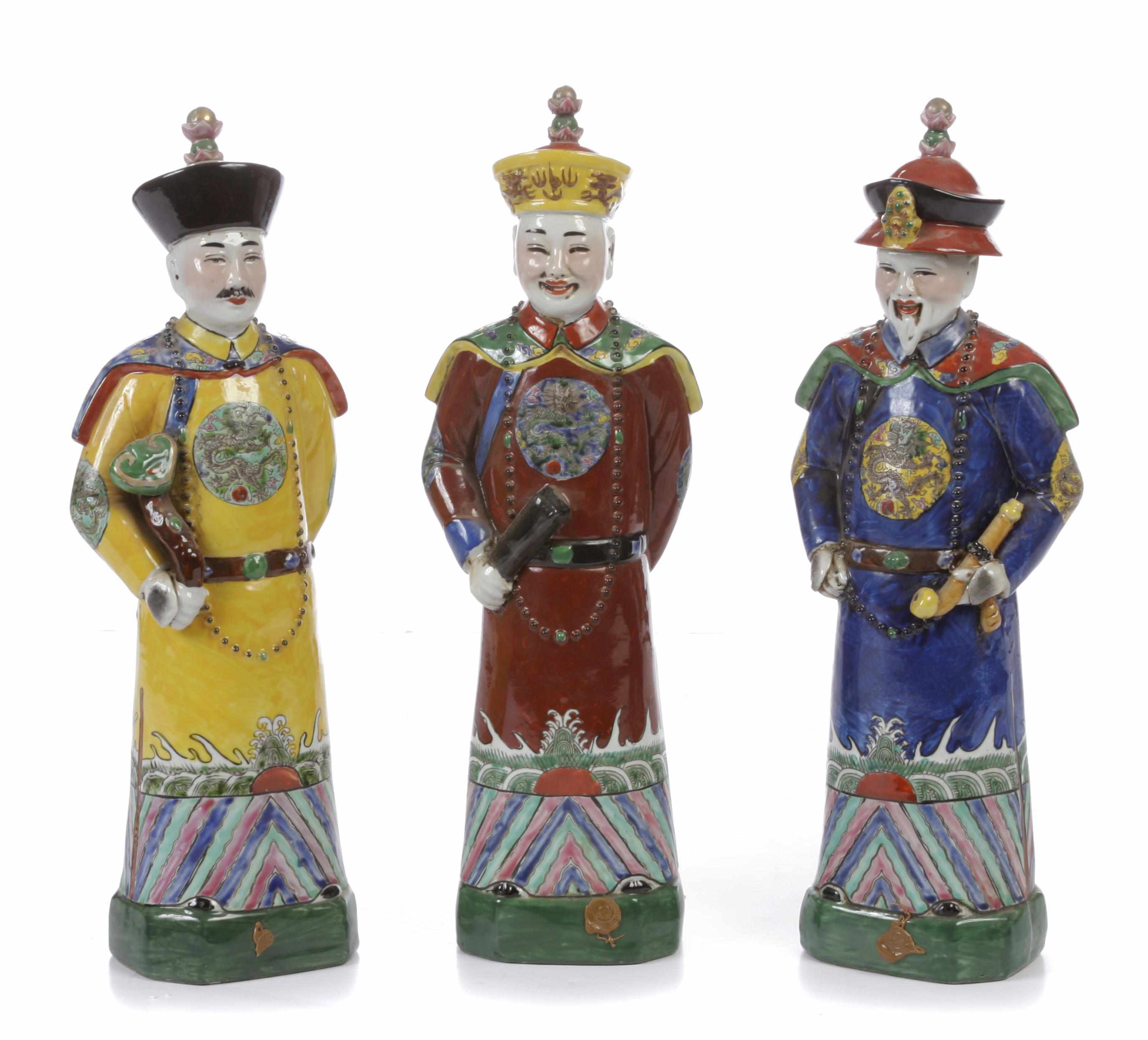 Appraisal: A set of three Chinese paint decorated porcelain figures of