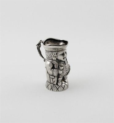 Appraisal: A continental novelty 'character' cream jug with a cast scroll